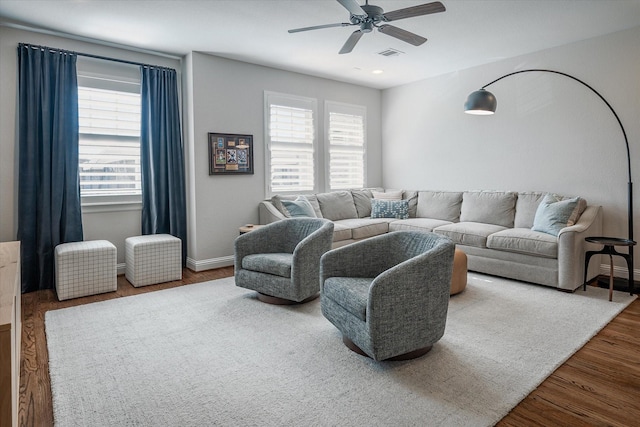 living room featuring ceiling fan, plenty of natural light, and hardwood / wood-style floors