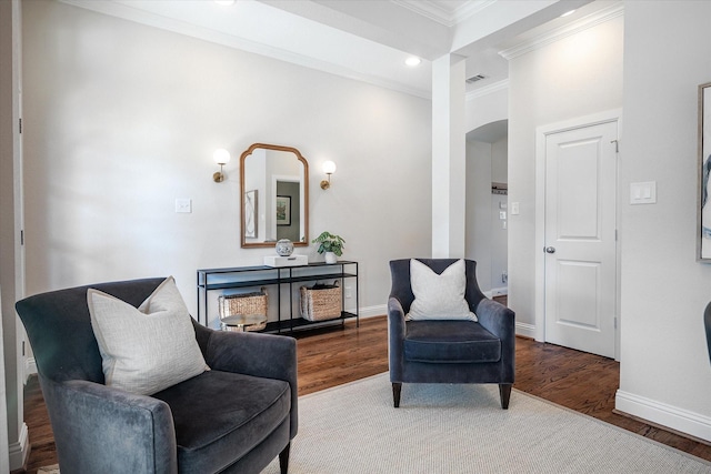 living area with ornamental molding and wood-type flooring