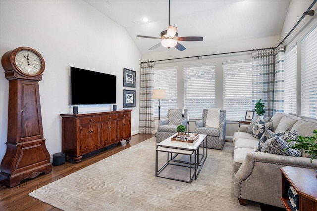 living room featuring ceiling fan, lofted ceiling, and hardwood / wood-style flooring