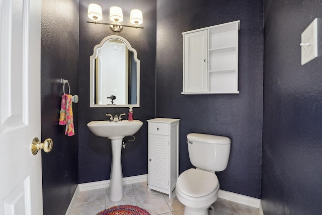 bathroom with tile patterned flooring and toilet