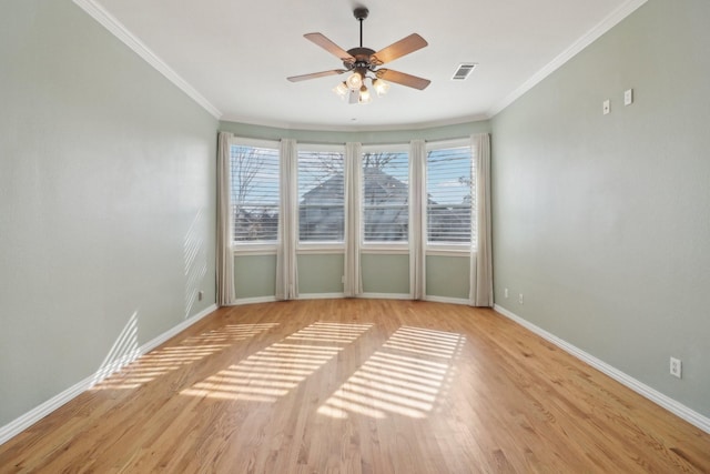 spare room featuring ornamental molding, ceiling fan, and light hardwood / wood-style floors