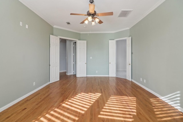 unfurnished bedroom featuring crown molding, ceiling fan, and wood-type flooring