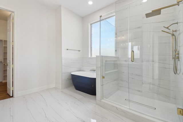 bathroom with plus walk in shower and tile walls