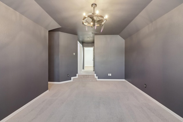 bonus room featuring light colored carpet and a notable chandelier