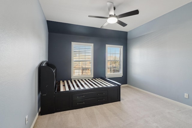 bedroom with ceiling fan and light colored carpet