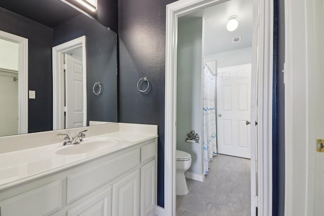 bathroom featuring vanity and toilet