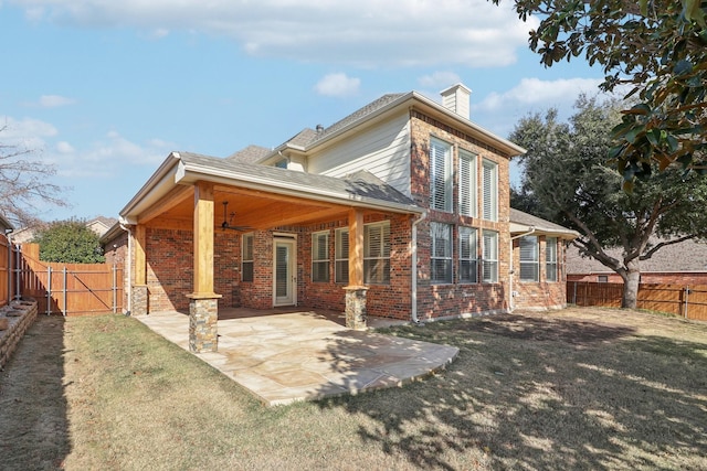 back of house featuring a yard, a patio, and ceiling fan