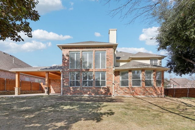 rear view of property with a yard