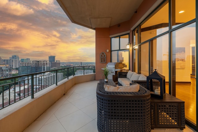 balcony at dusk featuring an outdoor hangout area