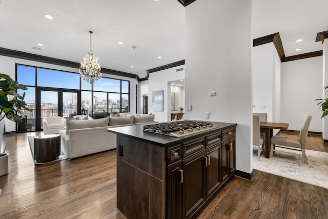 kitchen featuring crown molding, stainless steel gas stovetop, and dark hardwood / wood-style flooring