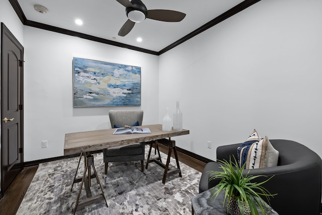 home office featuring dark wood-type flooring, ornamental molding, and ceiling fan