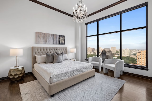 bedroom featuring wood-type flooring, a notable chandelier, and crown molding