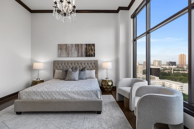 bedroom featuring an inviting chandelier, ornamental molding, and hardwood / wood-style floors