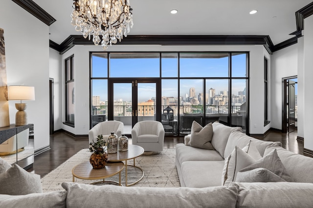 living room featuring hardwood / wood-style floors, ornamental molding, and a chandelier