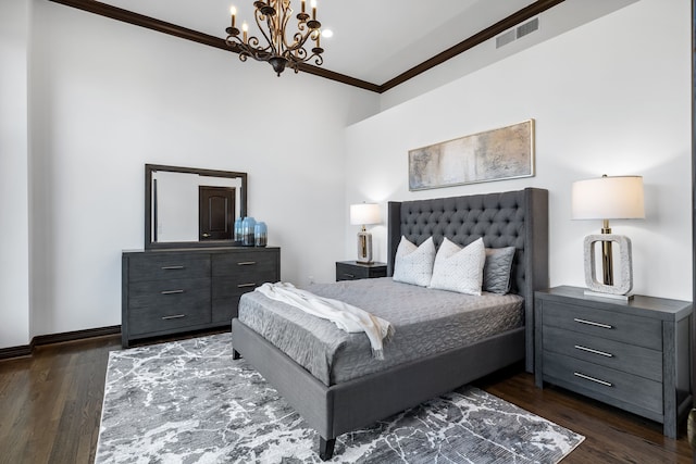 bedroom featuring dark wood-type flooring, ornamental molding, and a notable chandelier