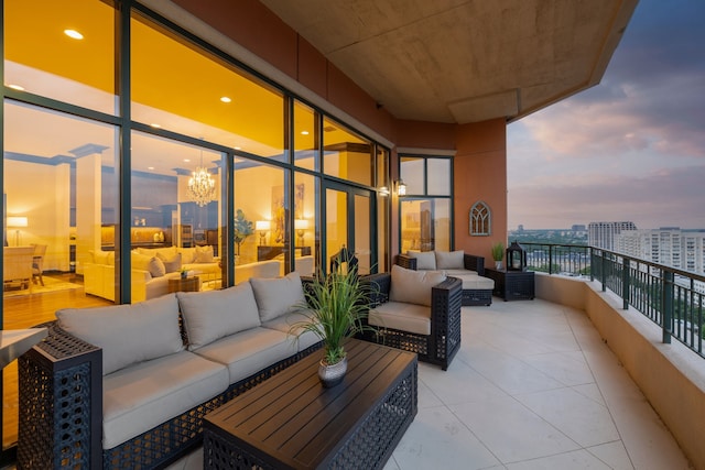 balcony at dusk featuring an outdoor hangout area