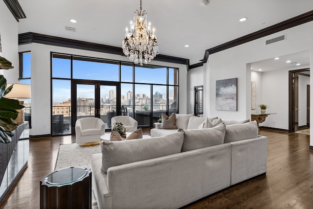 living room featuring dark hardwood / wood-style flooring, crown molding, and a notable chandelier