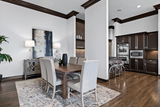 dining space featuring dark hardwood / wood-style floors and crown molding