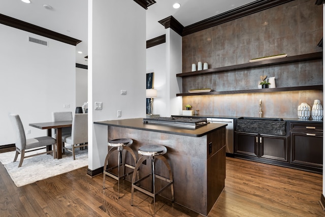 bar featuring stainless steel dishwasher, dark hardwood / wood-style flooring, sink, and crown molding