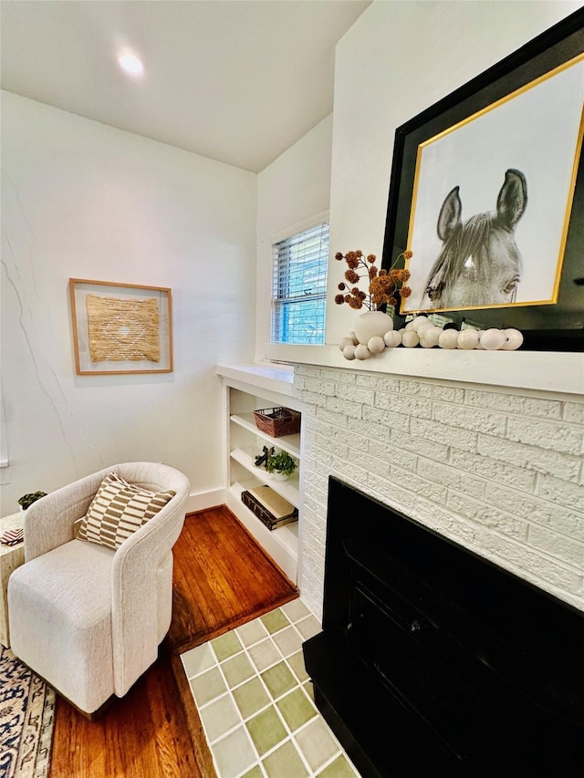 sitting room with a fireplace and dark hardwood / wood-style floors