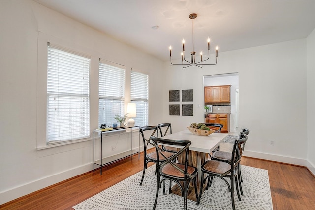 dining space featuring a chandelier and light hardwood / wood-style flooring