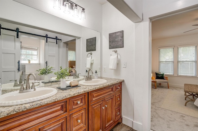 bathroom with ceiling fan and vanity