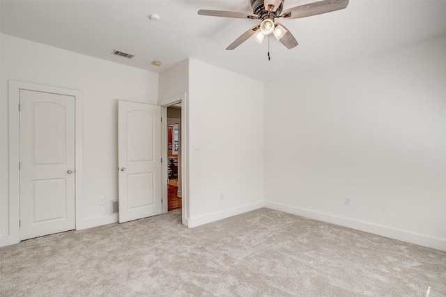 unfurnished bedroom featuring ceiling fan and light carpet