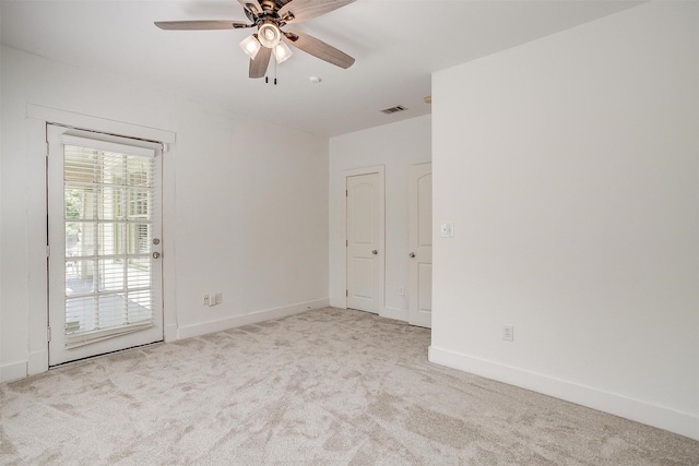 unfurnished room with ceiling fan and light colored carpet