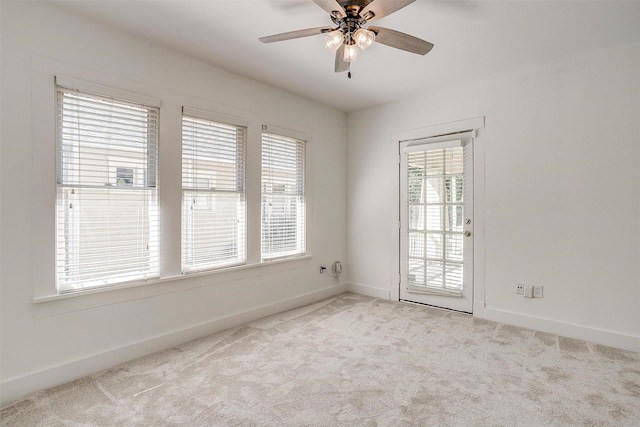 unfurnished room with ceiling fan and light carpet