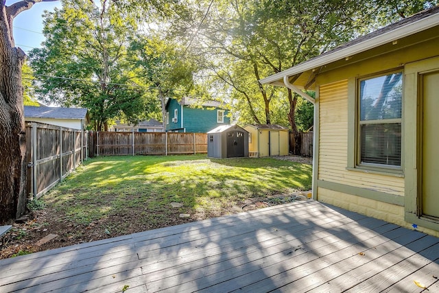 wooden deck with a yard and a storage shed