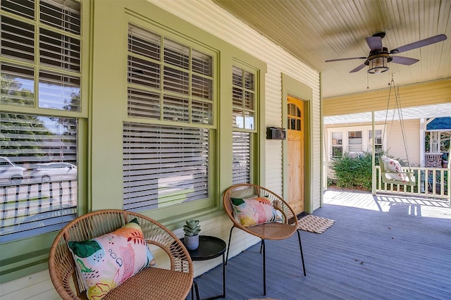 wooden terrace featuring ceiling fan and covered porch