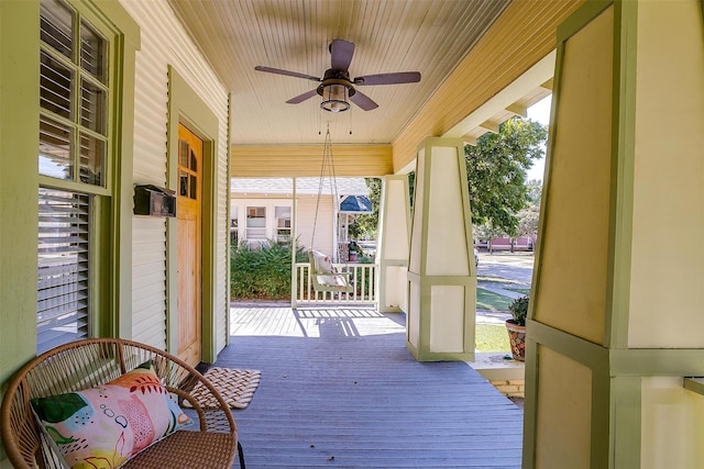 wooden deck with ceiling fan and a porch