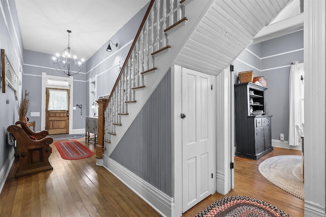 entrance foyer with a chandelier and wood-type flooring