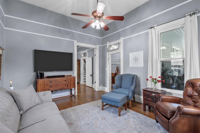 living room featuring ceiling fan and wood-type flooring