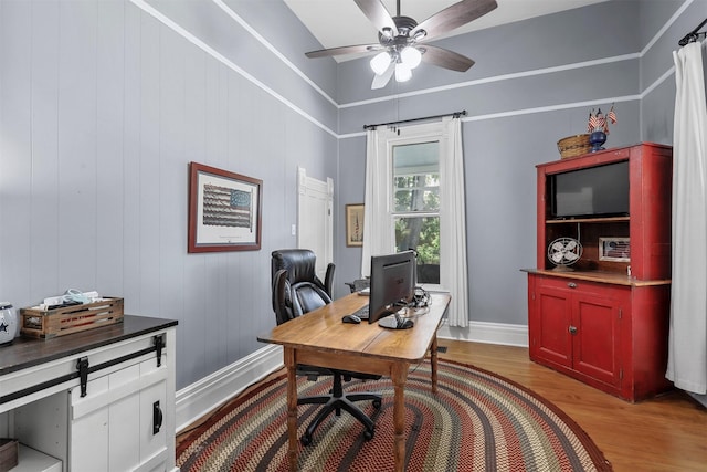 home office featuring ceiling fan and light hardwood / wood-style flooring