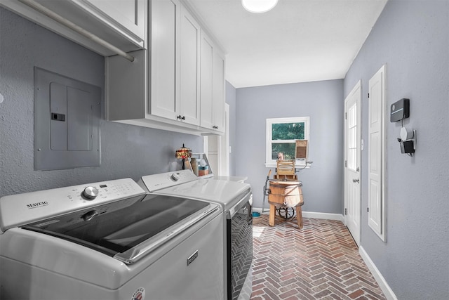 washroom featuring independent washer and dryer, electric panel, and cabinets