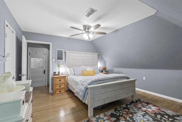 bedroom featuring ceiling fan, light hardwood / wood-style floors, and lofted ceiling