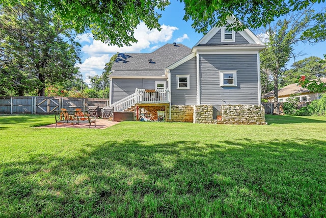 back of house with a patio area and a lawn