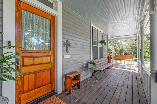 wooden terrace with a porch