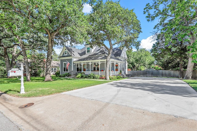 view of front of property featuring covered porch and a front yard