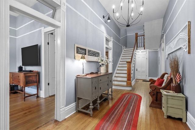 entrance foyer featuring an inviting chandelier and light hardwood / wood-style flooring