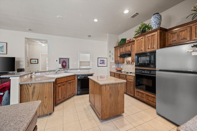 kitchen with a center island, black appliances, decorative backsplash, sink, and light tile patterned floors