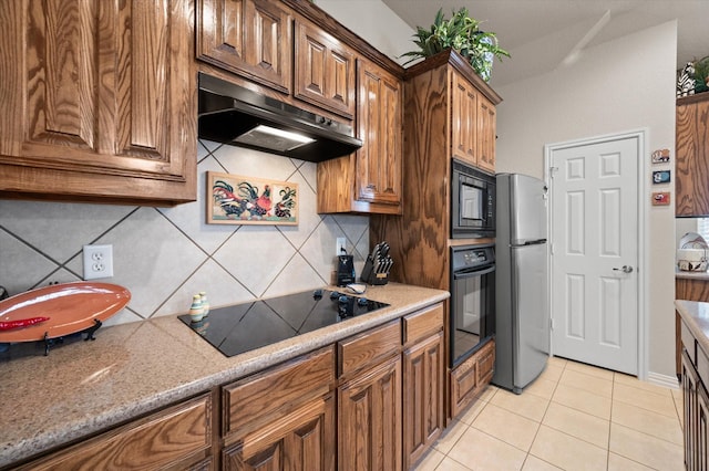 kitchen featuring black appliances, light tile patterned floors, and tasteful backsplash