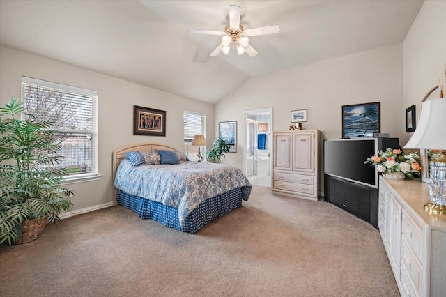 carpeted bedroom featuring ceiling fan, ensuite bathroom, and lofted ceiling