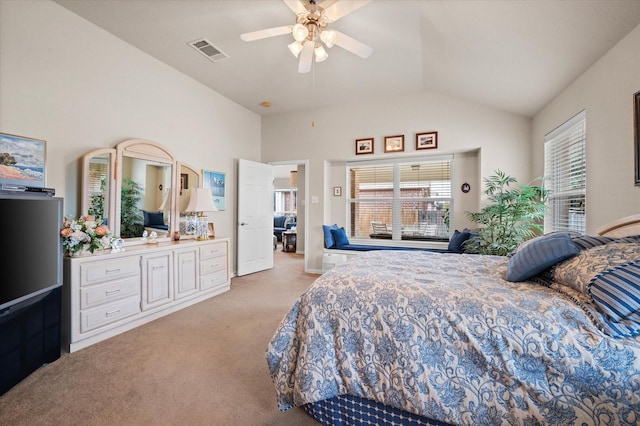 carpeted bedroom with ceiling fan and vaulted ceiling