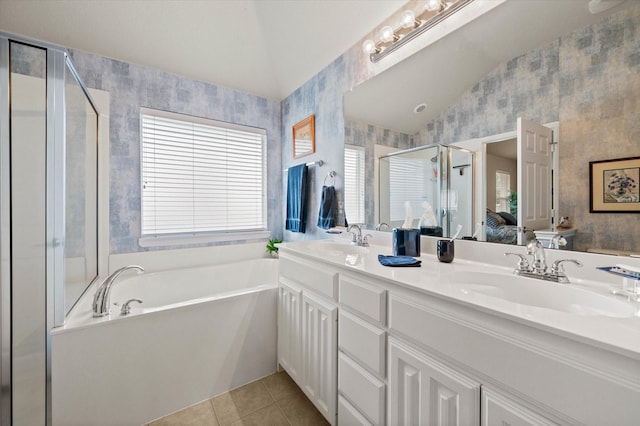 bathroom featuring plus walk in shower, vanity, lofted ceiling, and tile patterned flooring