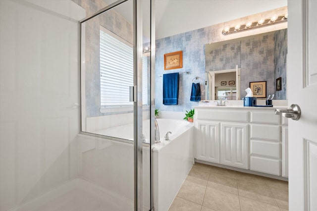 bathroom featuring tile patterned floors, vanity, and shower with separate bathtub