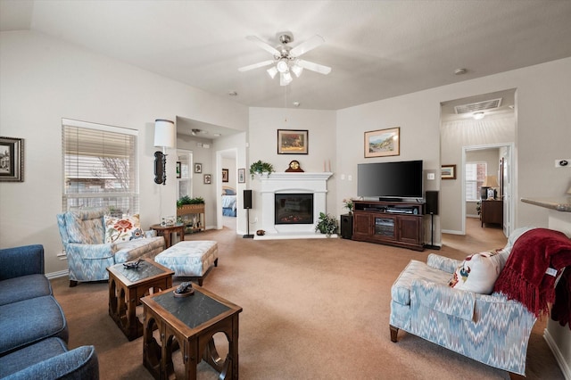 living room with ceiling fan, a wealth of natural light, and carpet floors