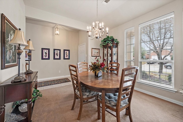 carpeted dining space featuring a wealth of natural light and an inviting chandelier