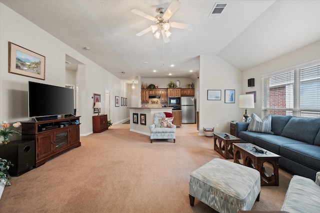 living room featuring ceiling fan, light colored carpet, and lofted ceiling